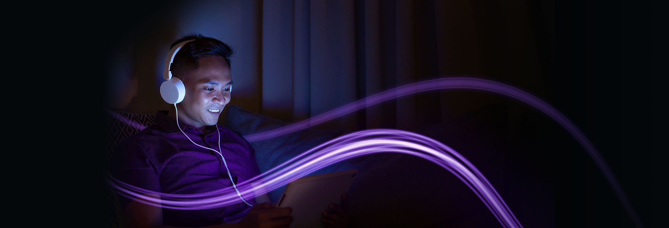 Man looking at tablet and sitting on the couch