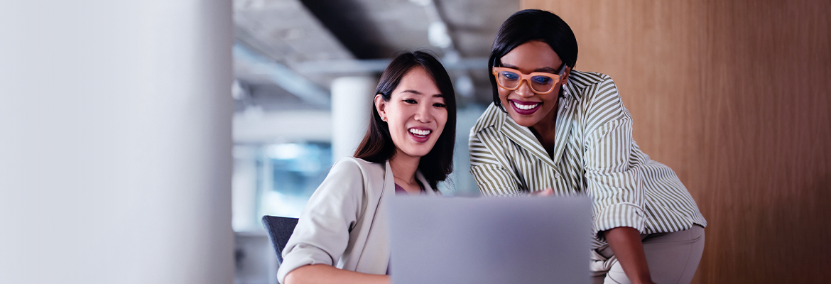 Two women looking at a laptop